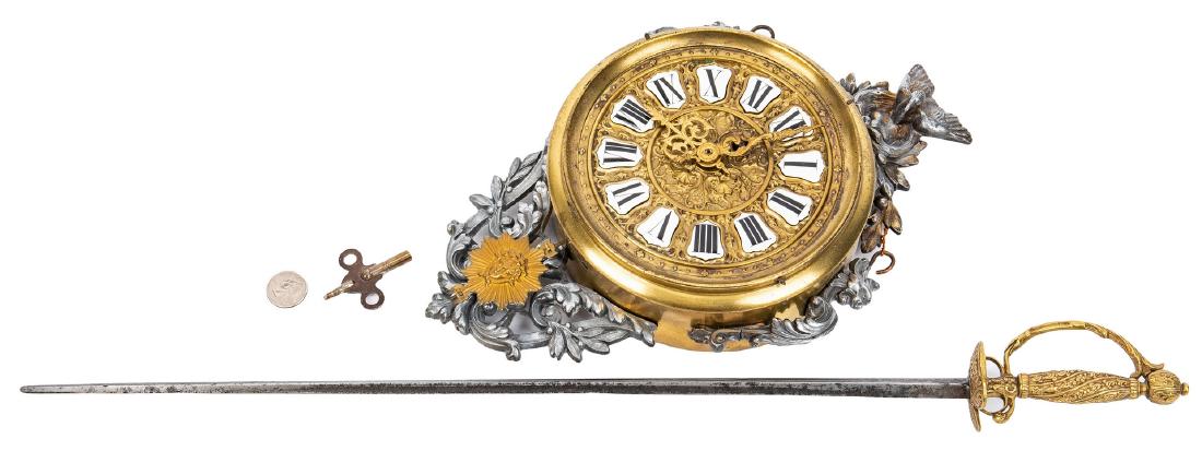 French Ormolu Wall Clock & French Petite Sword: French Ormolu Wall Clock and French Petite Sword, 2 items total. 1st item: Ormolu wall clock with a round gilt metal body and enameled Roman numerals, surmounted by a bird in nest foliate finial, side