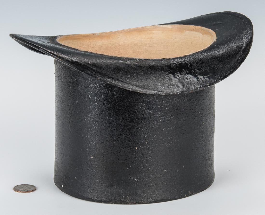 Cast Iron Top Hat Spittoon or Planter: Late 19th century black painted cast iron spittoon or planter, top hat form with enamel painted interior. Marked on the base. 7" H x 10 1/2" D x 8 1/2" W. Weight 10.2 lbs. Provenance: Estate of intern