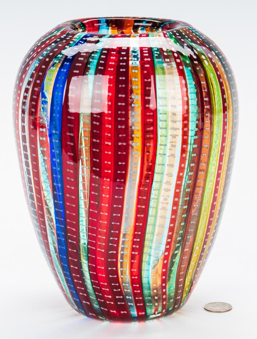 Murano Cenedese Art Glass Vase: Italian Murano Cenedese latticino caned art glass vase, in colors of red, blue, orange and green. Incised "Cenedese" on the base. Two (2) labels to bottom. 9 3/4" H. 20th century. (Additional high-res