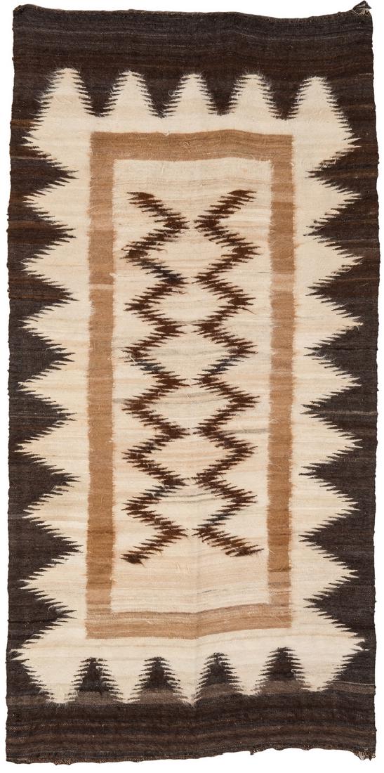 Native American Navajo Eye Dazzler Rug: Native American Navajo Eyedazzler rug, woven in colors of brown, cream, and tan, circa 1970s. 66" x 32 1/2". Provenance: Estate of Celia (Cece) Webb, Nashville, TN. (Additional high-resolution photos