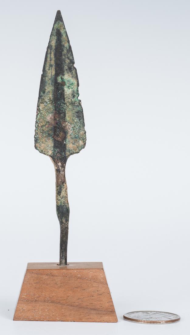 Iranian Amlash Culture Bronze Spear Tip: Iranian Amlash culture bronze spear tip with a central spine and double edged blade. Mounted to wooden base with black attribution labels. Spear point - 4 1/4" H x 1" W x 1/4" D. Overall - 5" H x 1 7/