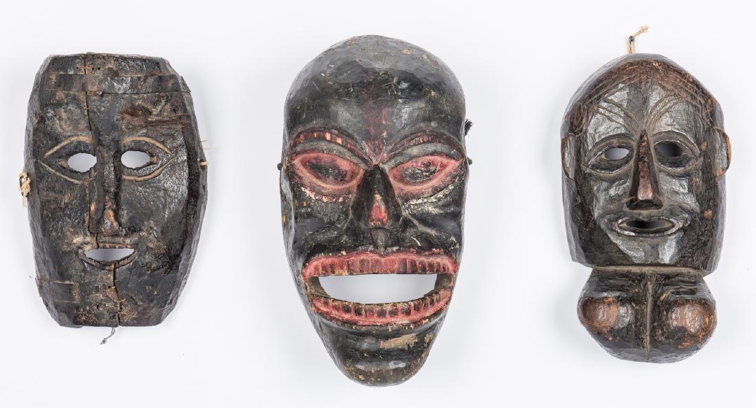 3 Himalayan Carved Masks: Three (3) Himalayan Masks, carved and painted wood, including male and female ceremonial masks and a Rakshasa mask with gaping mouth. All India or Nepal, late 18th to early 19th century. Provenance: O