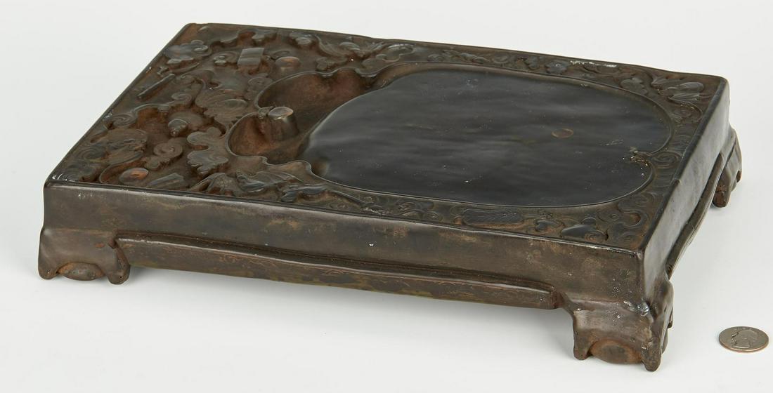 Chinese Duan Inkstone with Bats: Elaborate and substantial Chinese inkstone, carved with bats flying in clouds with precious scholar objects, the rectangular form raised on molded bracket feet. 2 1/4" H x 12" L x 8 1/8" D. Republic P