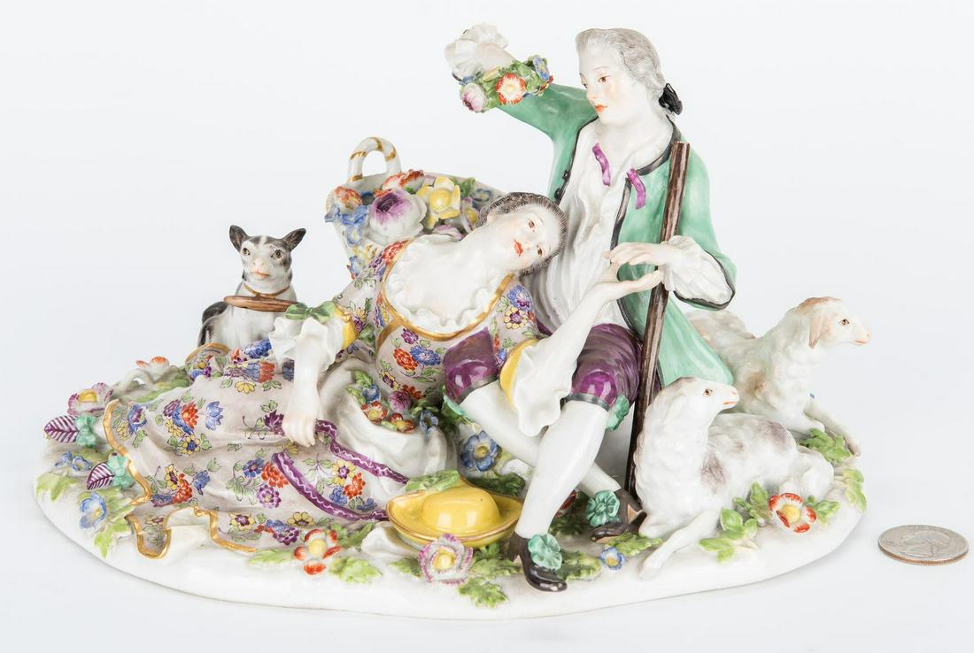 Meissen Courting Couple w/ Sheep Figural: German Meissen polychrome and parcel gilt figural depicting young lovers reclining on a naturalistic base with recumbent sheep, dog and flower basket. Blue underglaze Meissen marked to base with one s