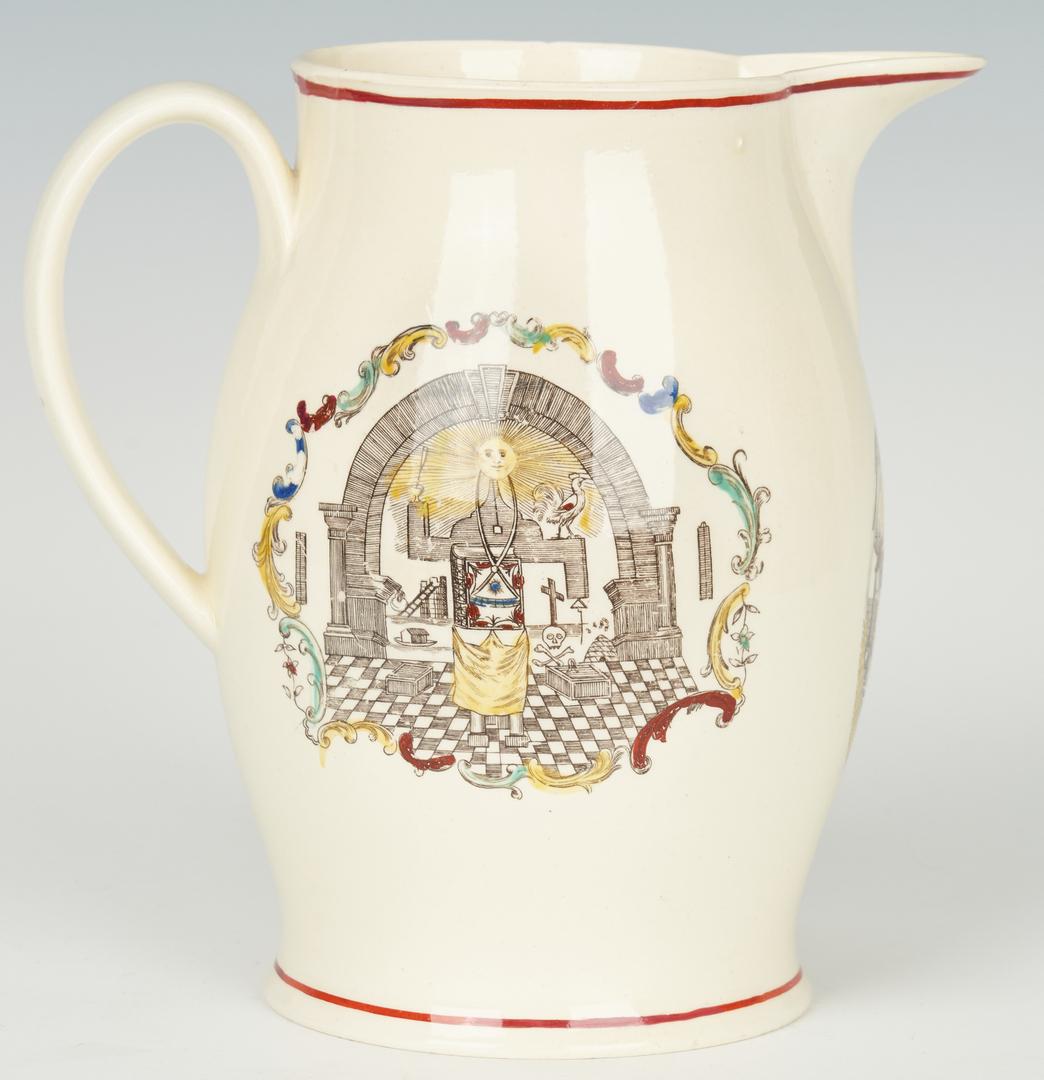 Liverpool Creamware Jug w/ Masonic Imagery: Liverpool creamware jug having a curving, melon shape with a pointed lip and strap handle. Polychrome transfer decoration including a red trim at top and base with Masonic imagery, symbols, and motifs