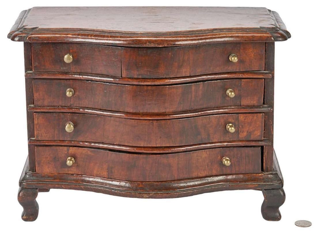 Miniature European Chest of Drawers: Miniature serpentine front chest of drawers, oak with pine secondary, molded serpentine top over a conforming case with four dovetailed drawers having brass knobs, molded serpentine base above four br