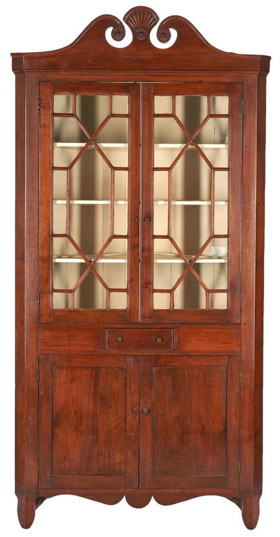 East TN Cherry Corner Cupboard, poss. Jacob Fisher: East Tennessee (McMinn County) one-piece walnut corner cupboard, yellow pine secondary. Possibly Jacob Fisher cabinetmaking shop. Comprised of a broken arch pediment with radial fan carved rosettes an