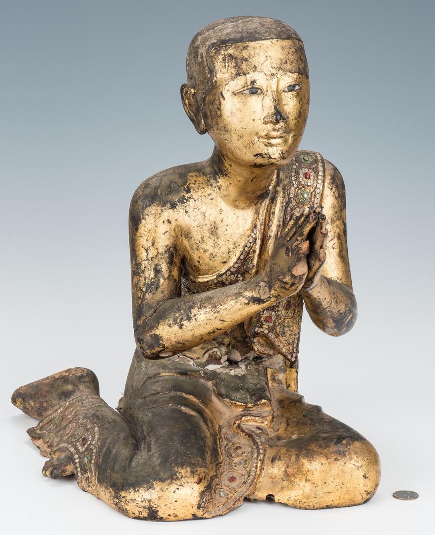 Carved Giltwood & Jeweled Buddhist Temple Monk: Carved giltwood Buddhist temple monk figure, depicted in a kneeling and praying posture, face with inset eyes, tunic with colored stone and shell inlay to the trim and shell inlaid fingernails on the 