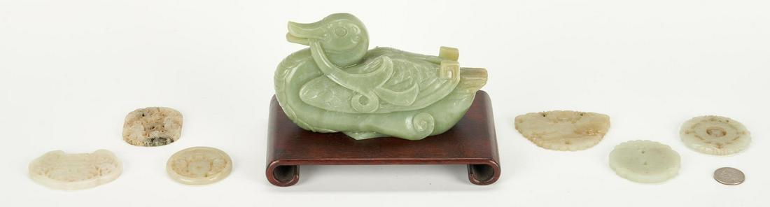 Chinese Carved Jade Duck and Plaques, 7 items: Seven (7) carved Chinese jade items, including duck figure and plaques. 1st item: Celadon jade recumbent duck figure. Illegible ink inscription to underside of base. Includes a later raised wooden sta