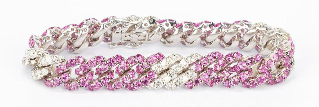 Ladies 18K Pink Sapphire & Diamond Link Bracelet: One ladies 18k white gold 11.6mm heavy curb link bracelet encrusted with rubies and diamonds in a 2x5 link pattern. There is a total of 64 full cut diamonds weighing a total of approximately 4.48 cara