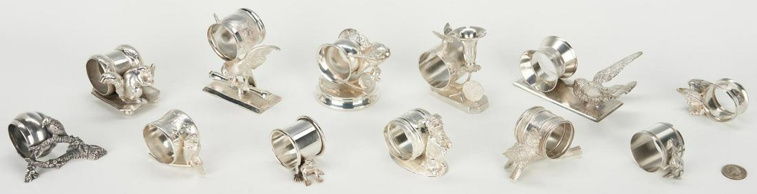 12 Silverplated Napkin Rings, incl. Animals: An assortment of twelve (12) silverplated napkin rings with figural animals including eagles, dog, butterfly, frog, owl, squirrel, bunny rabbit, and assorted birds. Maker's marks include Rogers (Squir