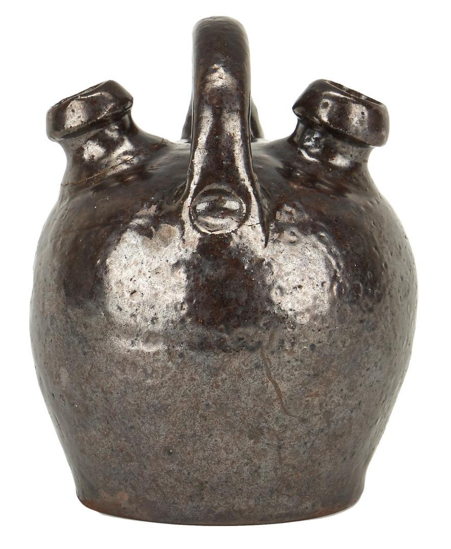 Southern Earthenware Monkey Jug, Dated 1866: Southern, Western NC or East TN earthenware "monkey" or harvest jug having a dark manganese glaze, central applied pulled handle between two spouts. Underside of base with incised date "1866" with an 
