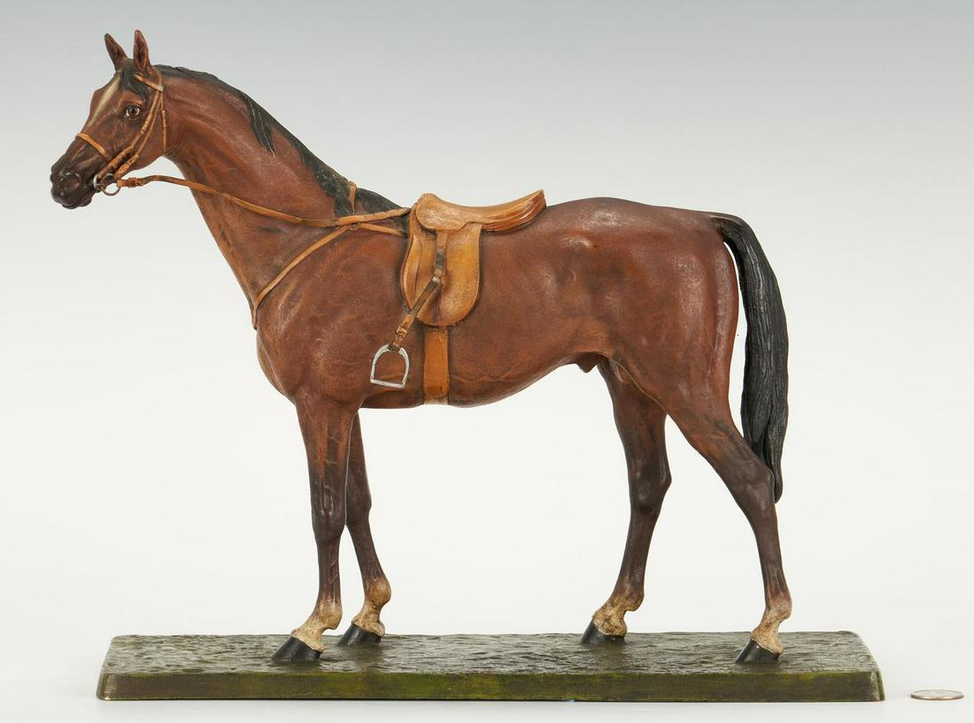 Carl Kauba cold painted bronze horse: Carl Kauba (Austrian, 1865-1922) cold painted bronze figure of a standing chestnut colored horse, wearing a saddle and reins. Signed "Kauba" at corner of base. 12" H x 14" W x 6" D. 20.06 lbs. Provena