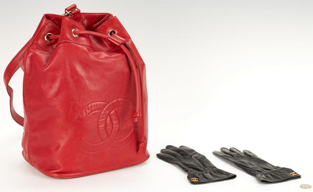 Chanel Leather Fashion Accessories, incl. Purse, Gloves: Chanel designer lambskin leather accessories, including one (1) bucket bag and one (1) pair of gloves, 3 items total. 1st item: Red drawstring bucket bag with shoulder strap, gold tone hardware. Embro