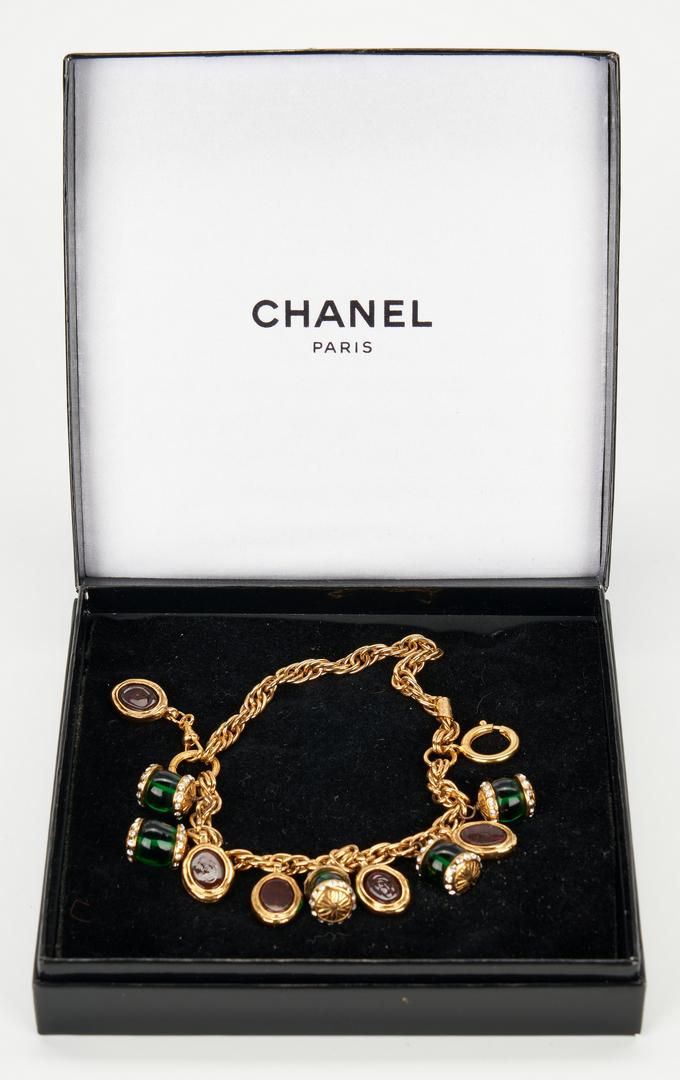 Chanel Gripoix Red & Green Gold Tone Charm Bracelet: Chanel gold tone double chain bracelet with ten (10) red and green gripoix glass charms and diamante crystal accents. Stamped "(copyright) (registered) CHANEL" with double "C" logo and "MADE IN FRANCE