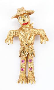 Ladies 18K Gold, Diamond, & Sapphire Scarecrow Pin: Ladies 18K yellow gold scarecrow pin featuring 2 single cut diamonds approximately 0.04 carats, Clarity-VS2, Color-I for the eyes. Black and red enamel accents the nose, mouth, and belt buckle. The