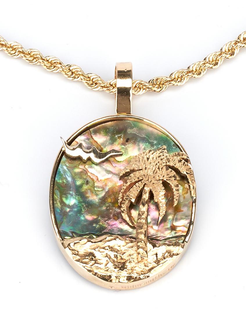 Ladies 14K Pendant & Rope Necklace: Grouping of one (1) ladies abalone pendant and one (1) 14K yellow gold rope necklace. 1st item: One ladies 14k yellow gold pendant framed around an oval 1.25x 1 inch piece of abalone with a gold palm