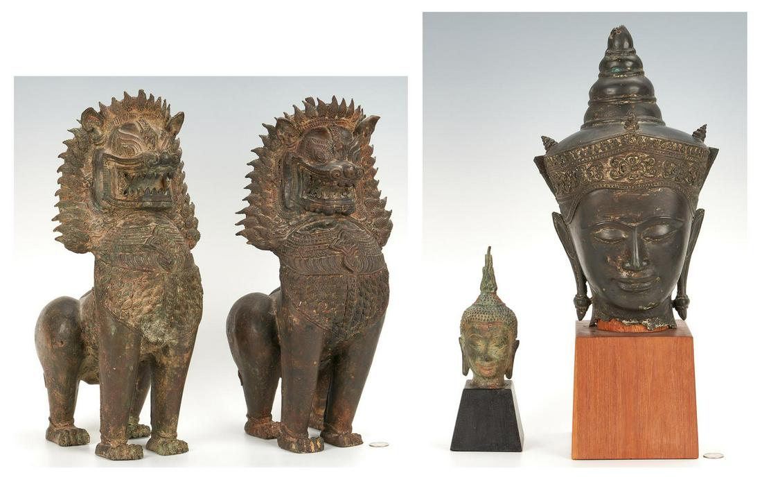 4 Asian Bronzes incl. Temple Dogs & Buddha: Four (4) Asian Bronze items, including Temple Dogs and Buddha heads. 1st & 2nd items: Pair of Southeast Asian patinated bronze foo or temple dogs depicted standing with open mouths, unmarked. 17 3/8" 