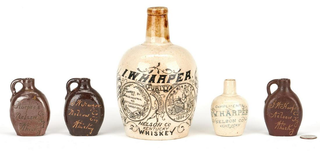 5 Kentucky I. W. Harper Stoneware Advertising Jugs: Group of five (5) I. W. Harper, Nelson Co., Kentucky stoneware advertising whiskey jugs including one (1) commemorative whiskey advertising jug from the 1885 World's Industrial and Cotton Exposition i