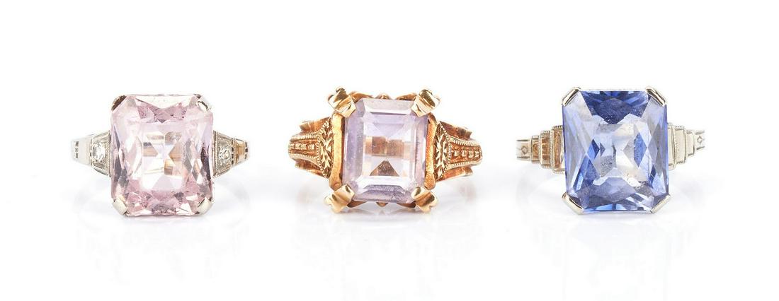 3 Gold Rings with Gemstones: 1st item: 10K white gold ring featuring one rectangular radiant cut pink spinel approximately 12 x 10mm accented by 2 single cut diamonds approximately 0.02 carats, Clarity-SI1, Color-H. The ring test