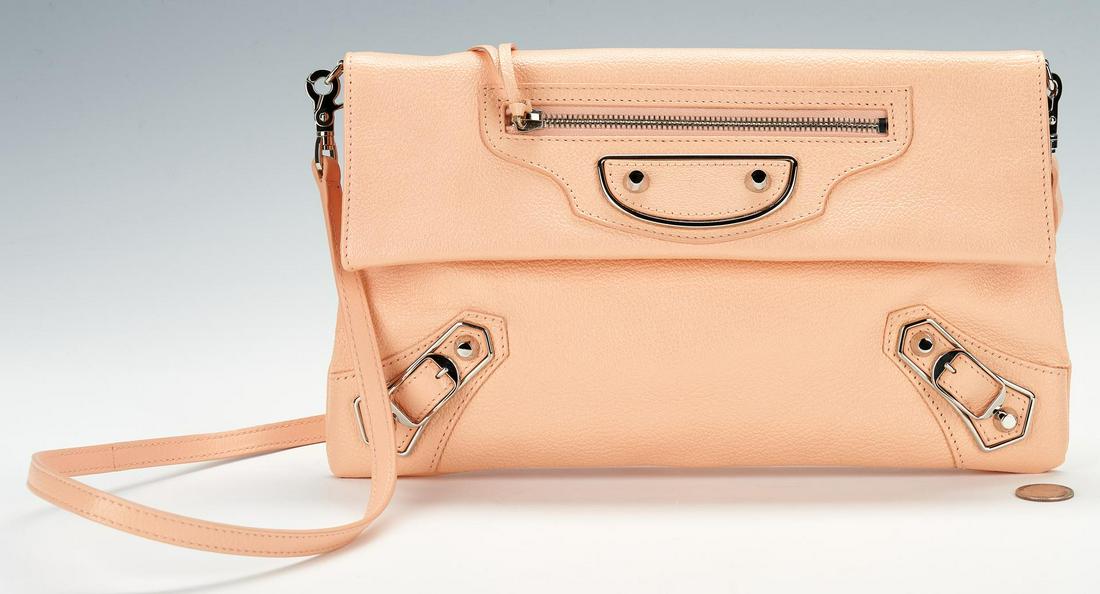 Balenciaga Light Coral Envelope Crossbody Bag: Balenciaga classic envelope light coral grained calfskin leather crossbody body, including detachable matching leather strap, studs, buckle details, and exterior pocket, silver tone hardware. Fold-ove