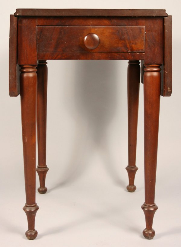 Cherry drop leaf work table: One drawer drop leaf work table in the Sheraton style, Southern or Mid Atlantic. Cherry with mahogany door front. Dovetailed drawer with wooden pulls on turned ring legs. Overall very good condition,