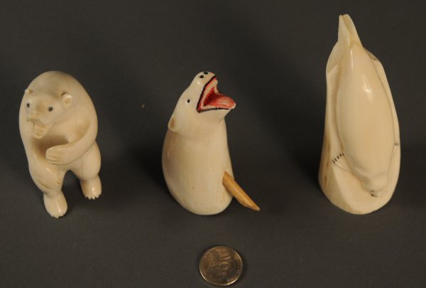 Lot of three Inuit and Alaskan ivory items: Lot of three ivory Inuit/Alaskan items. 1st item - Carved ivory seal with applied decoration. 3 1/2" Length x 1 1/2" Width. 2nd item - Carved ivory bear with applied decoration. 3 1/2" Length. 1 1/4"