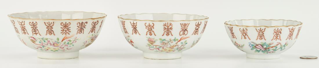 3 Guangxu Famille Rose Porcelain Nesting Bowls: Three (3) Chinese Famille Rose porcelain bowls of graduated sizes, Guangxu mark and period, each with scalloped gilt rims and bodies above polychrome enamel painted bands of Shou symbols and the attri