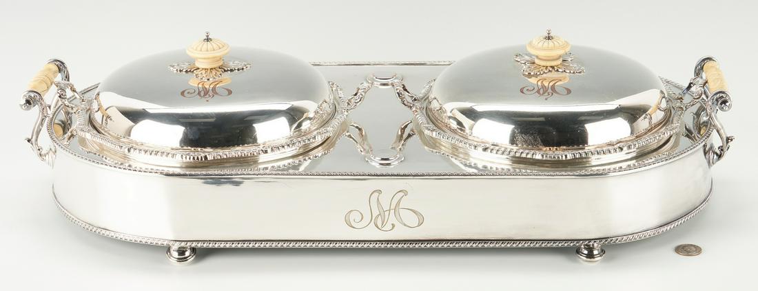 Double Supper Server or Entree Dish: Double supper server or entree warmer, silver on copper with ornate handles, comprised of two removable round covered dishes, fitted into a long oblong server with gadrooned edges, atop compressed bal