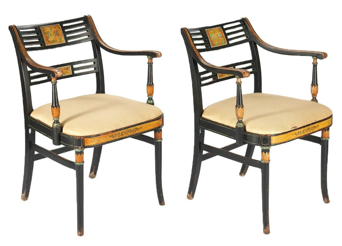 Pair Paint Decorated Sheraton Style Armchairs: Pair of Sheraton style armchairs, each with polychrome decoration on an ebonized ground; rectangular pierced slats having central floral vignettes, curved and molded arms resting on baluster supports 