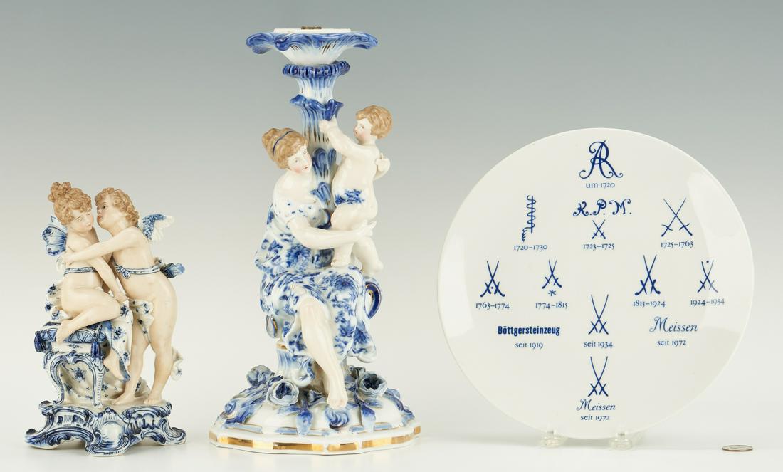 Figural Candlestick, Meissen Plate & Cherub: Three (3) Blue and White Porcelain items, including Meissen and Sitzendorf. 1st item: Figural candlestick depicting a woman in blue and white gown, seated with a cherub on her lap, who holds a stalk-f
