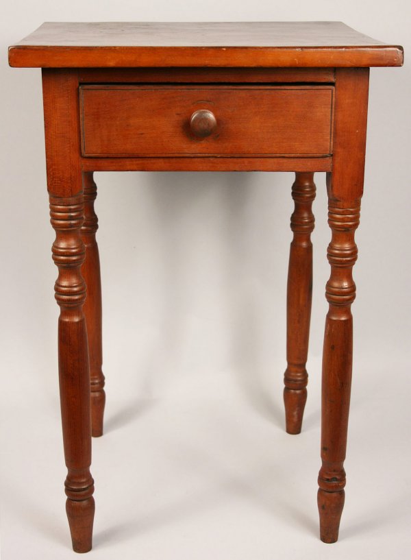 One drawer stand, probably Pennsylvania: One drawer stand, probably Pennsylvania, comprised of cherry primary, poplar and white pine secondary. Old red wash with turned legs and dovetailed drawer with wooden pull. Refinished with overall exp