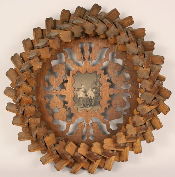 Tramp art folk art frame, elaborate hearts & hands: Elaborately pieced tramp art/folk art picture frame with cut out heart and hands design, contains a 19th century family portrait. Very good condition. Measures 15"H x 12 3/4"W. Late 19th century.