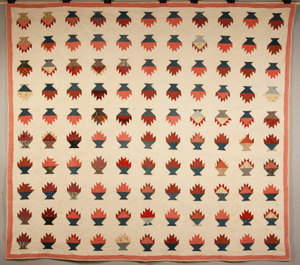 Amish quilt: Amish quilt, flower basket design. Pieced, comprised of various fabrics, red dot fabric border, with pinwheel design stitching. Found in Middle Tennessee. Note - the purposeful imperfections in the qu
