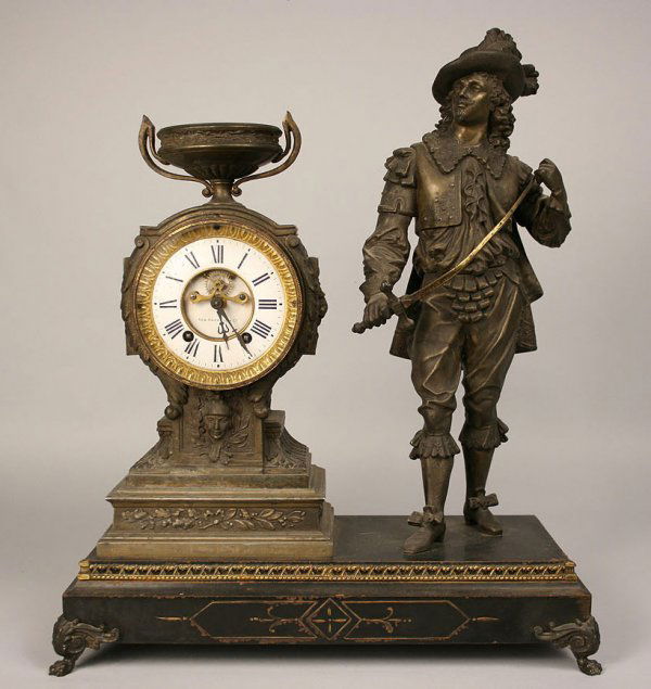 Figural mantle clock, New Haven Clock Co.: Open escapement figural mantle clock by New Haven Clock Company. Overall good condition with old patination and some paint losses to base. 21" Height x 17" Length x 7" Depth. 19th century.