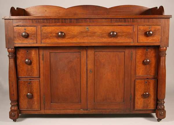 Tennessee cherry sideboard, Sumner Co.: Tennessee cherry sideboard with flame figured cherry or walnut veneers and poplar secondary wood. Shaped backsplash, overhanging top section with long center drawer topped by veneered freize and flank