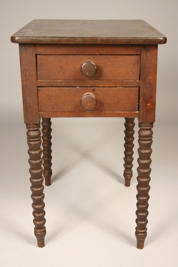 Alabama two-drawer work table.: Southern two drawer work table found in Northern Alabama, with rounded top, wooden drawer pulls and unusual conical turned legs. Signature on bottom of top drawer. Condition - Top has been refinished.