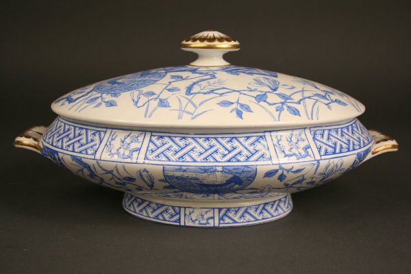 Minton covered vegetable dish: Minton covered vegetable dish in the aesthetic movement style. Blue and white with gilt decoration on finial and handles. Excellent condition. 5" Height x 13" Length x 8 1/4" Depth. Circa 1865-
