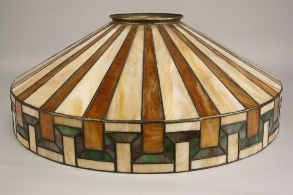 Arts & Crafts leaded slag glass lamp shade: Arts & Crafts conical leaded slag glass lamp shade with cream, brown, green and rose colors forming a geometric pattern. Unmarked. Excellent condition. 22" D. Early 20th century.