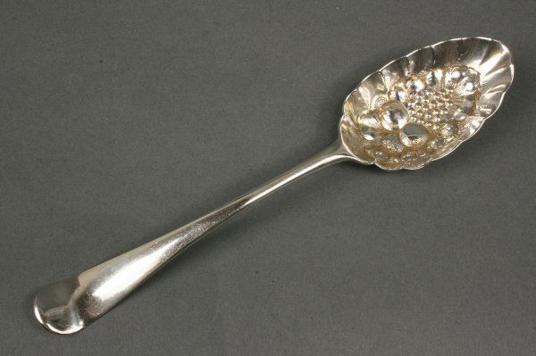 George III English sterling silver berry spoon: Parcel gilt berry spoon with elaborate repoussé bowl, upturned oval handle, no monogram. Hallmarks for London, 1772, GS in script (probably George Smith). Minor scratching, overall excellent conditio