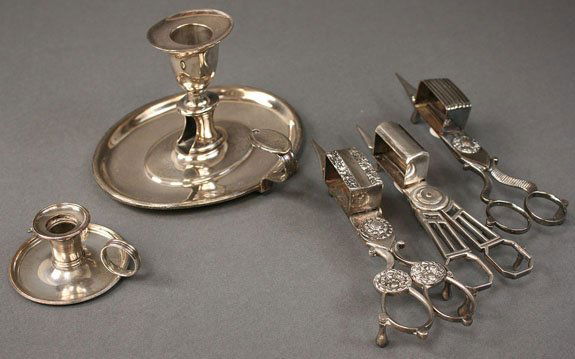 3 candle snuffers trimmers and 2 chambersticks: 5 candle related objects. Lot consists of 3 Old Sheffield silver plated wick trimmers or candles snuffers, one marked "Gilbert" in script with cross and triangle mark (probably John Gilbert, Birmingha