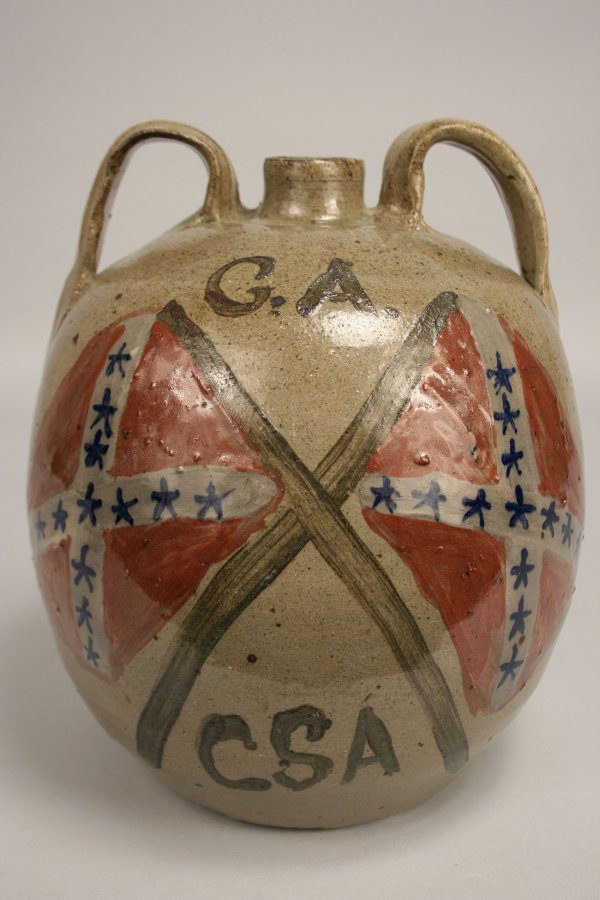 Confederate Pottery jug, Chester Hewell: Confederate Pottery Jug, Chester Hewell, with double applied handles depicting painted confederate flags, folk dancers and "G. A. CSA" under glaze. Incised on base, "Chester Hewell, CSA, 1999." Overal