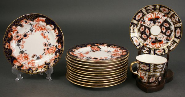 Imari style Royal Crown Derby Bread Plates: Grouping of Imari style Porcelain dinnerware. 1st item - Set of Twelve Royal Crown Derby Bread and Butter plates, hand painted and gilded with Imari style decoration. Marked "Royal Crown Derby, Englan