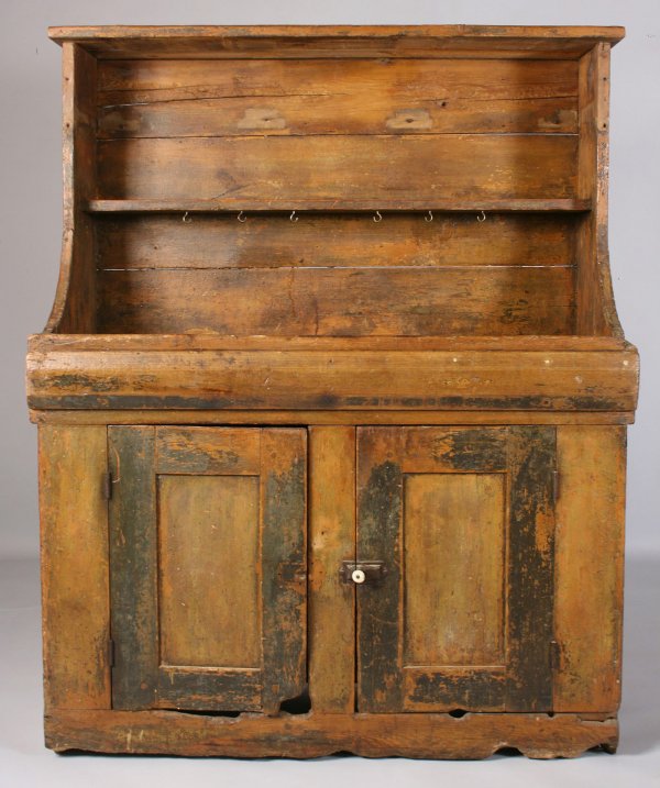 Painted dry sink, possibly Southern: Painted open dry sink pine, possibly yellow pine, consisting of large back splash with two open shelves, one with later added hooks for hanging, over two lower doors. Doors with old black paint outlin