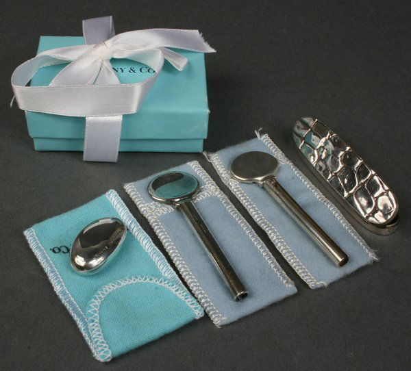 4 sterling silver accessories, Tiffany & English: Lot of four sterling silver accessories including one (1) Tiffany sterling silver worry stone with box and ribbon, two (2) Tiffany sterling toothpaste rollers and one (1) sterling pill or needle box,