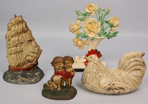 grouping of painted doorstops: Lot of painted cast iron door stops, 4 items. 1st item - Painted cast iron sailing ship door stop. Overall good condition with general wear to paint. 9" H. 20th century. 2nd item - Painted cast iron f