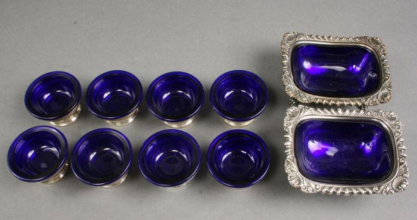 Lot of Sterling and Plated Salt cellars: Lot of Sterling and silver plated salt cellars. Includes Eight (8) sterling silver salt cellars with cobalt glass liners, 1 3/8" H x 1 7/8" Diameter, plus two (2) plated silver footed master salt dish