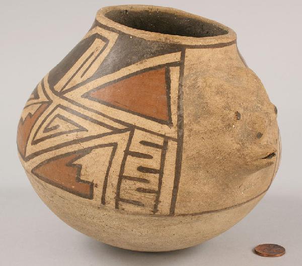 Southwest Indian Acoma effigy jar: Southwest Native American Acoma or Santa Domingo pottery Effigy Vessel with the face and tail of an animal and with hand-painted geometric designs in colors of sienna and brown. Overall very good cond
