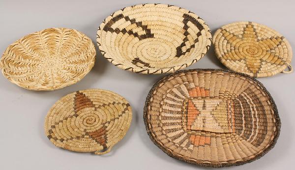 Five Native American Basket Weavings: Lot of Five Native American Baskets: One with the image of a Kachina, 2 Hopi coil baskets, and 1 Papago basket, and 1 other, all of varying colors of brown, red, orange and tans and ranging in diamete