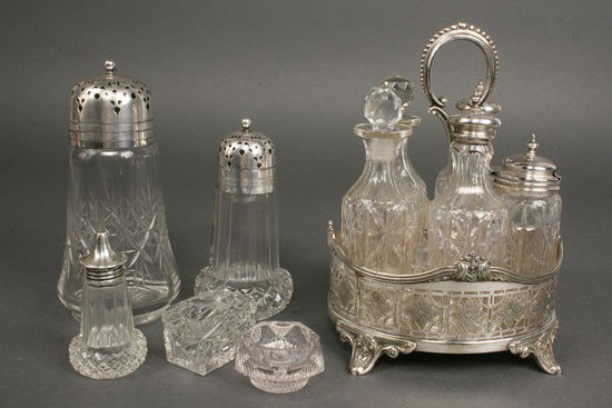 Silver and Glass Condiment Servers: Lot of Victorian or Edwardian silverplated and glass condiment items. Cruet set with pierced silverplated frame, five glass bottles, excellent condition (minor chips to stoppers). 8" height. Plus thre